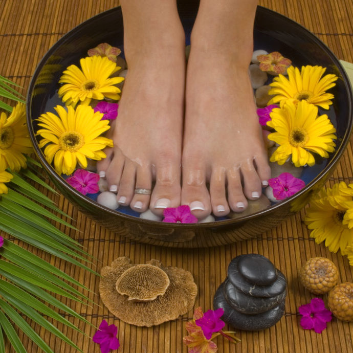 Spa treatment with aromatic gerbera daisies, healing stones, olive oil soaps and mineral water